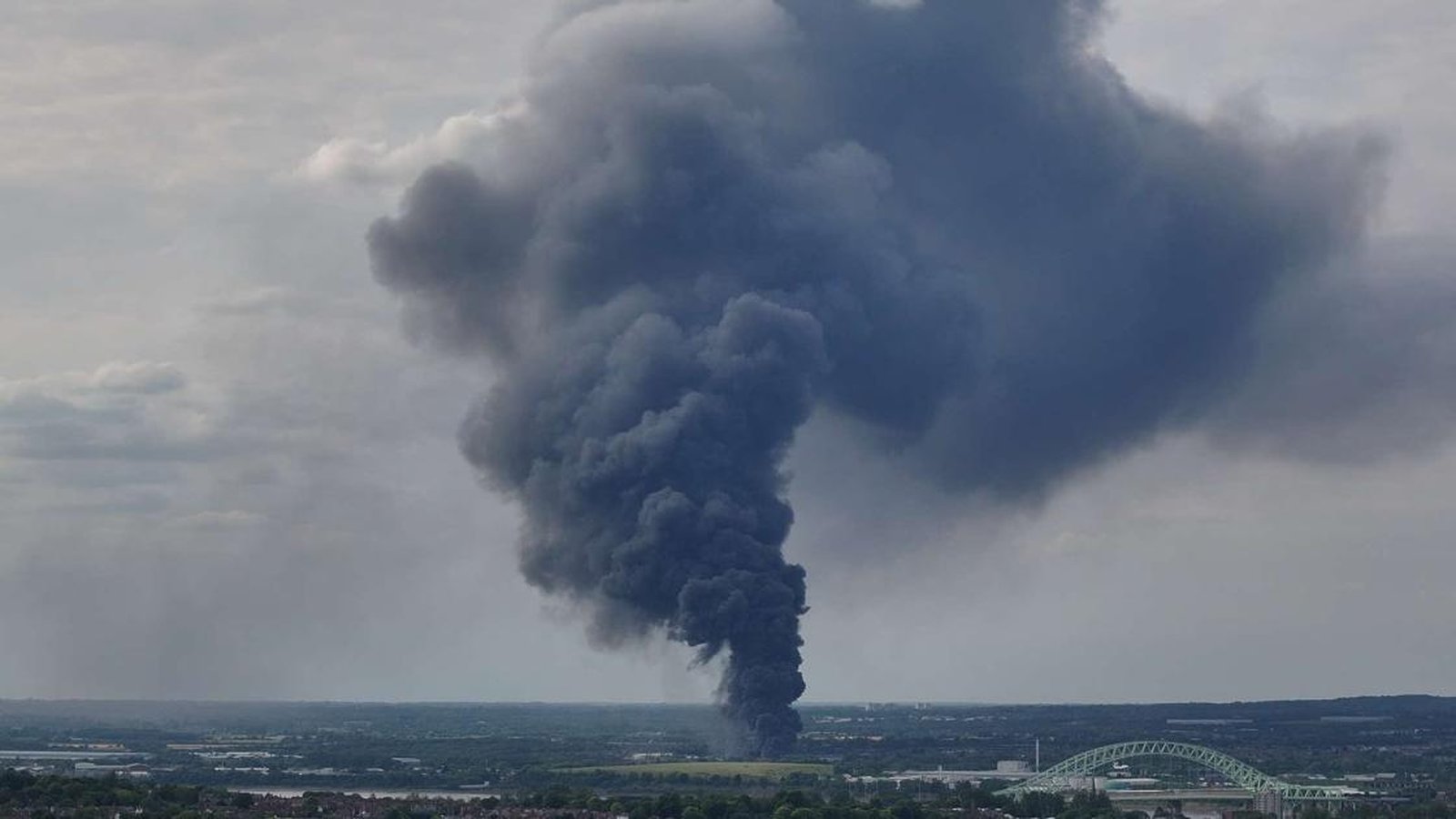 A massive plume of dark smoke rising from a recycling plant in Widnes