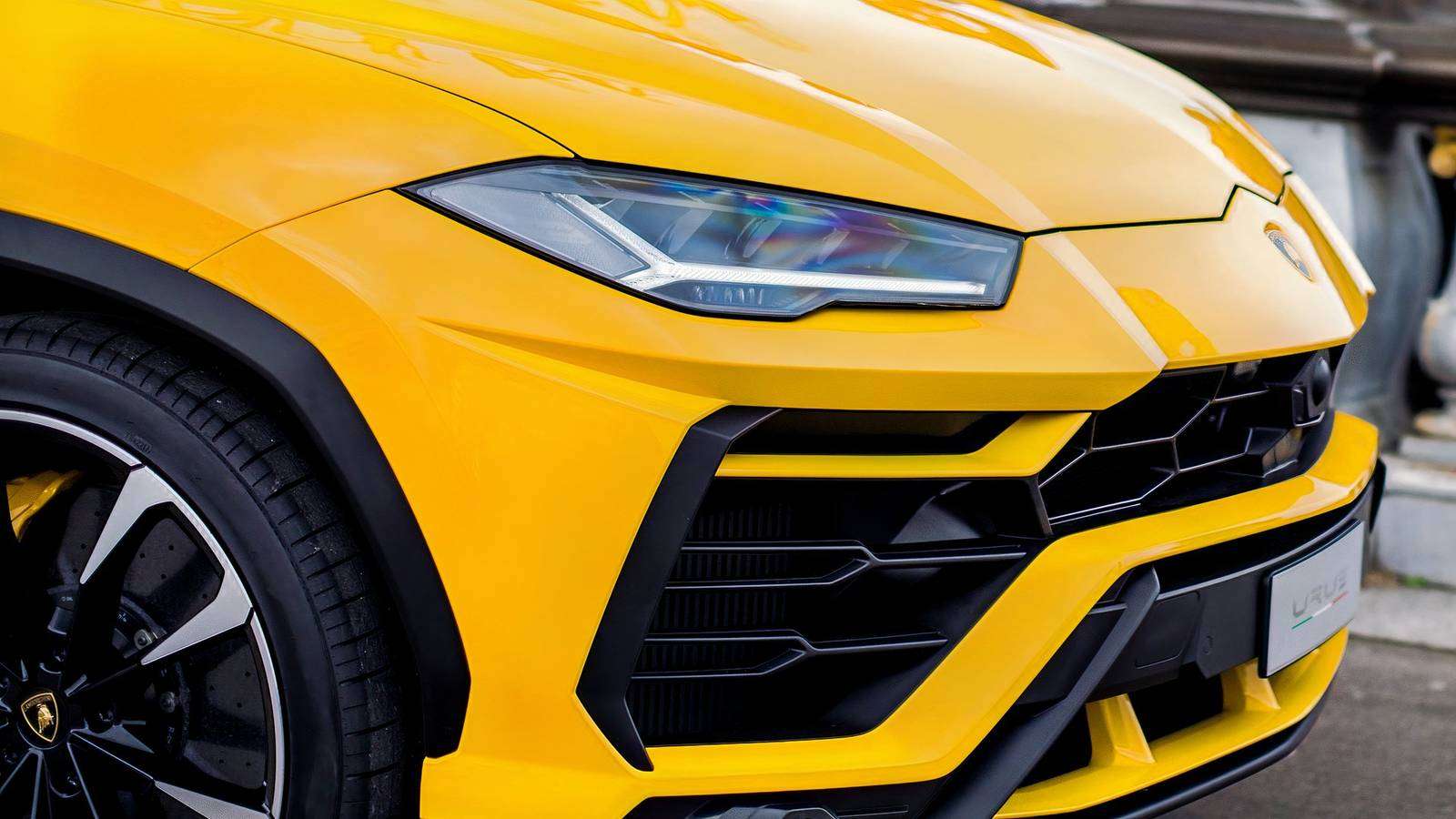 Close up front view of a bright yellow Lamborghini Urus luxury performance SUV