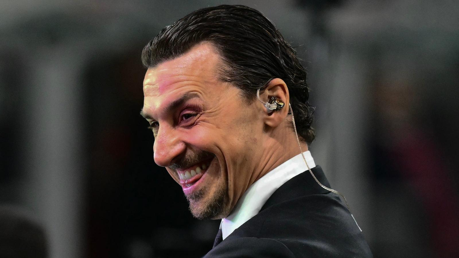 Zlatan Ibrahimovic smiling while wearing an earpiece during a professional sports broadcast
