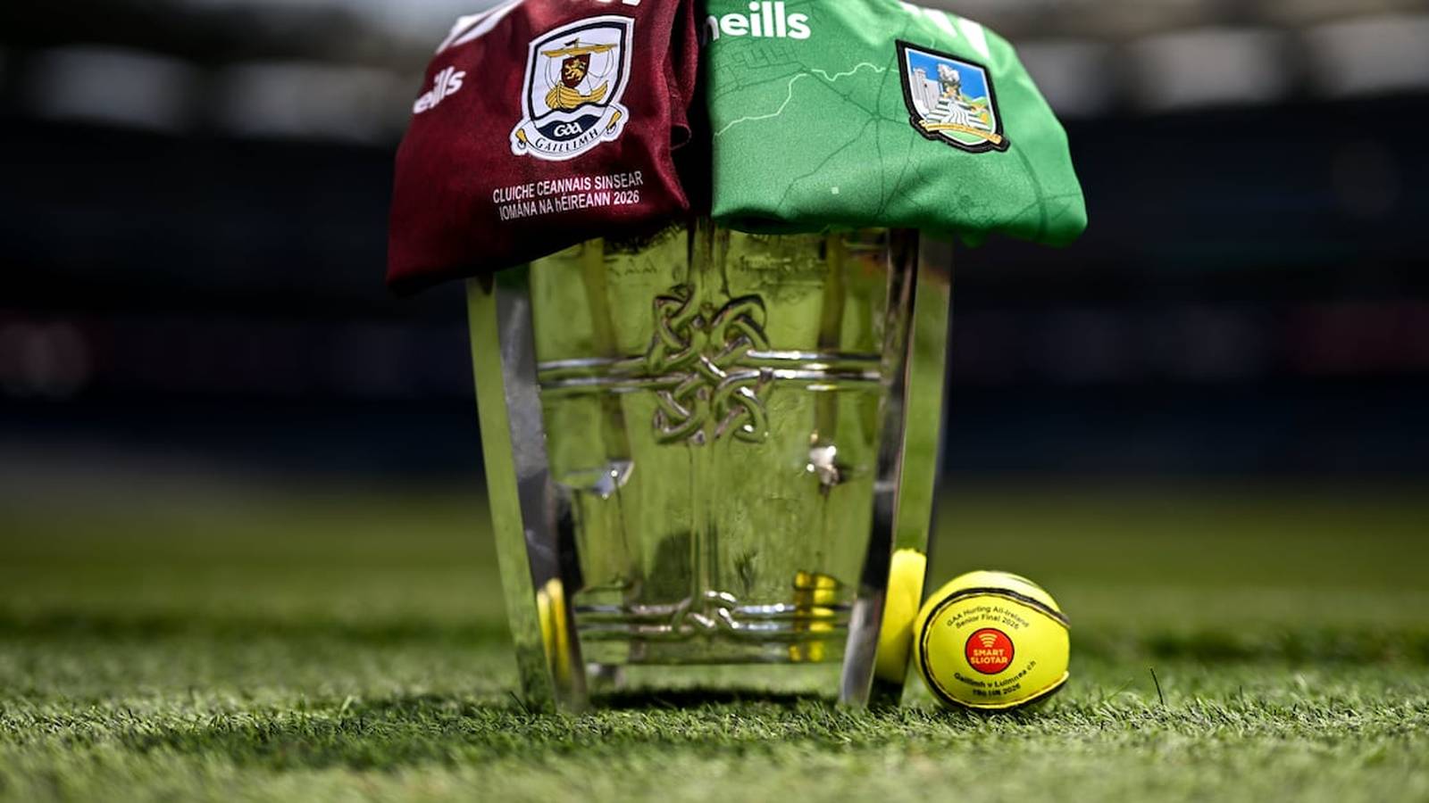 The Liam MacCarthy Cup with Galway and Limerick jerseys and a match sliotar