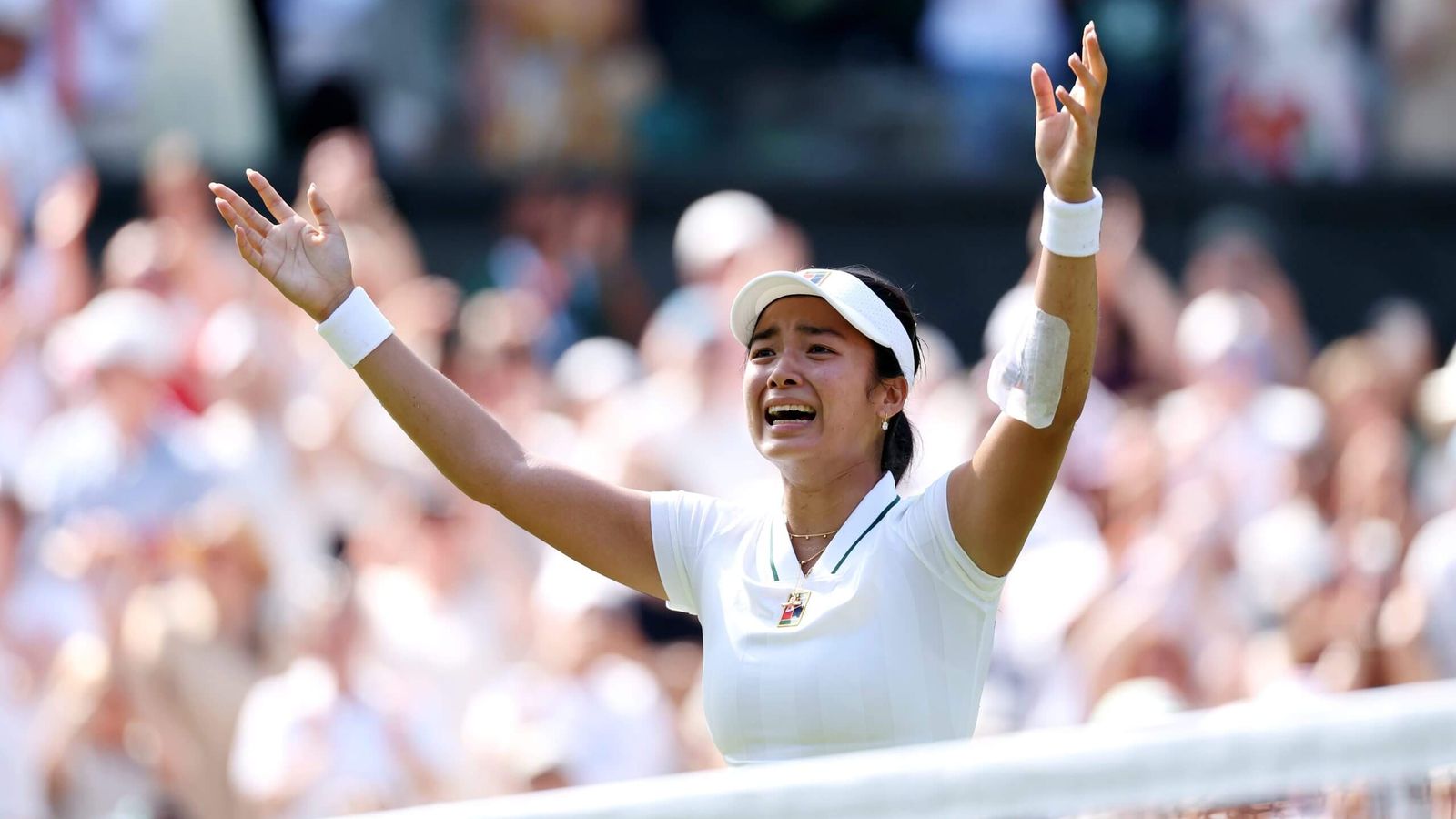 Alexandra Eala celebrating with arms raised after a victory at Wimbledon tennis tournament