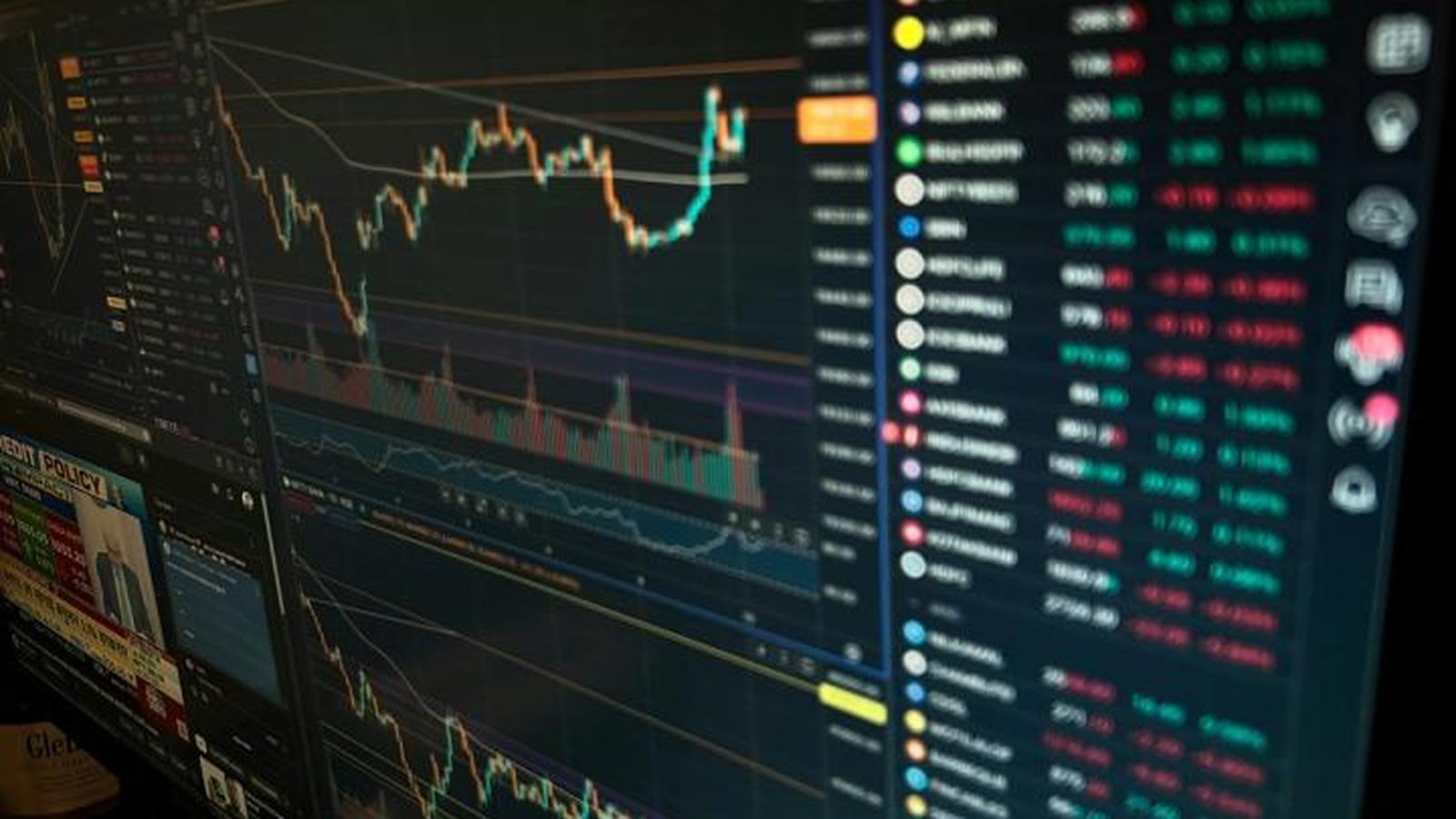 A computer monitor displaying complex financial trading charts and real-time market data