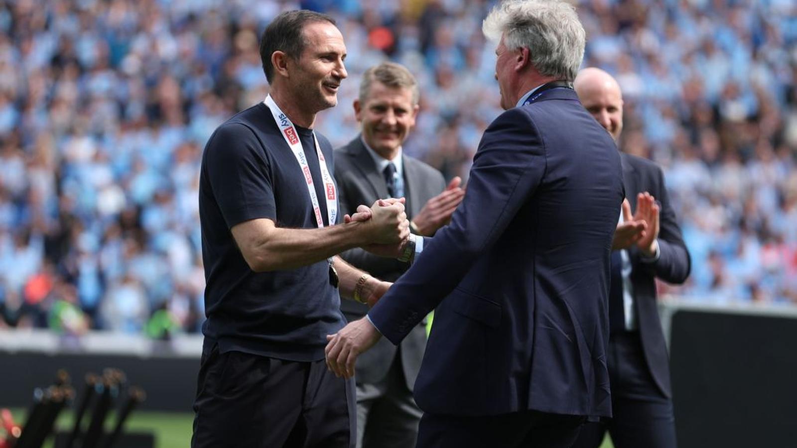 Frank Lampard shaking hands with a colleague on a football pitch