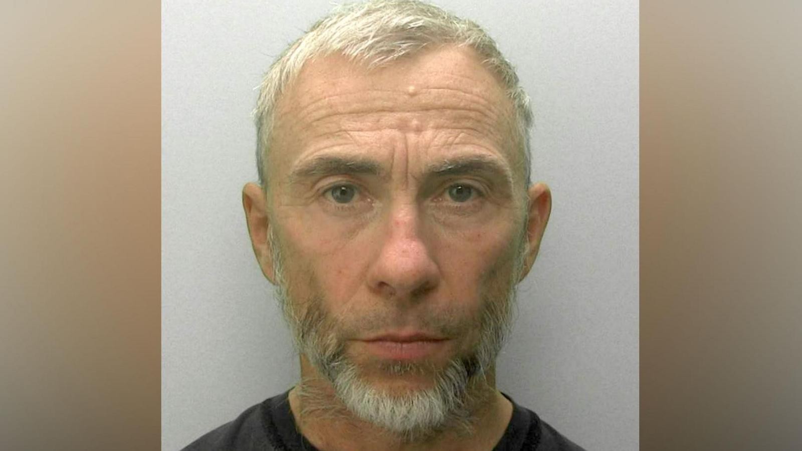 Official police mugshot of Superdry co-founder James Holder against a plain grey background