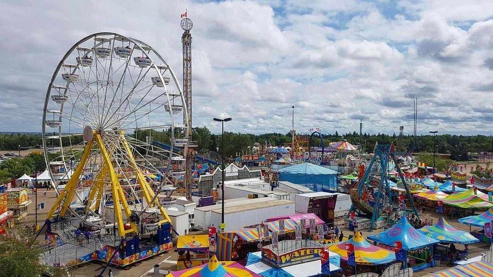 Aerial view of the KDays festival midway featuring a large ferris wheel and colorful carnival tents