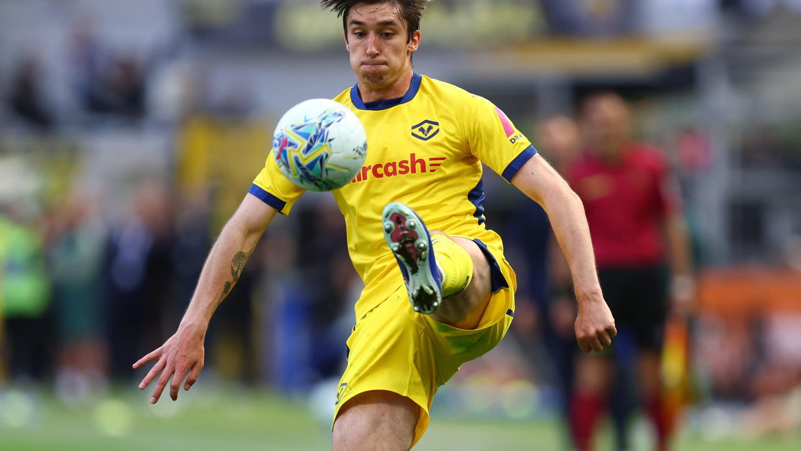Kieron Bowie controlling the ball during a professional football match in yellow kit