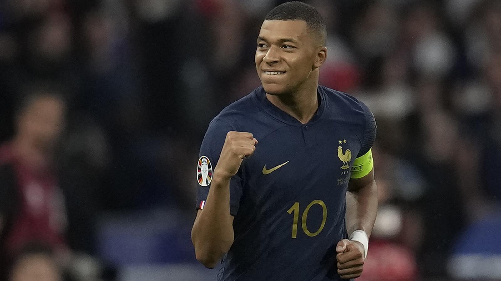 Kylian Mbappé wearing the France national team jersey celebrating a goal on field