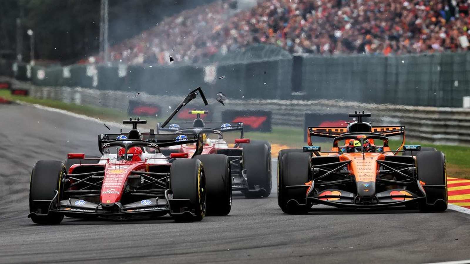 Charles Leclerc and Oscar Piastri colliding during the Formula 1 Belgian Grand Prix race