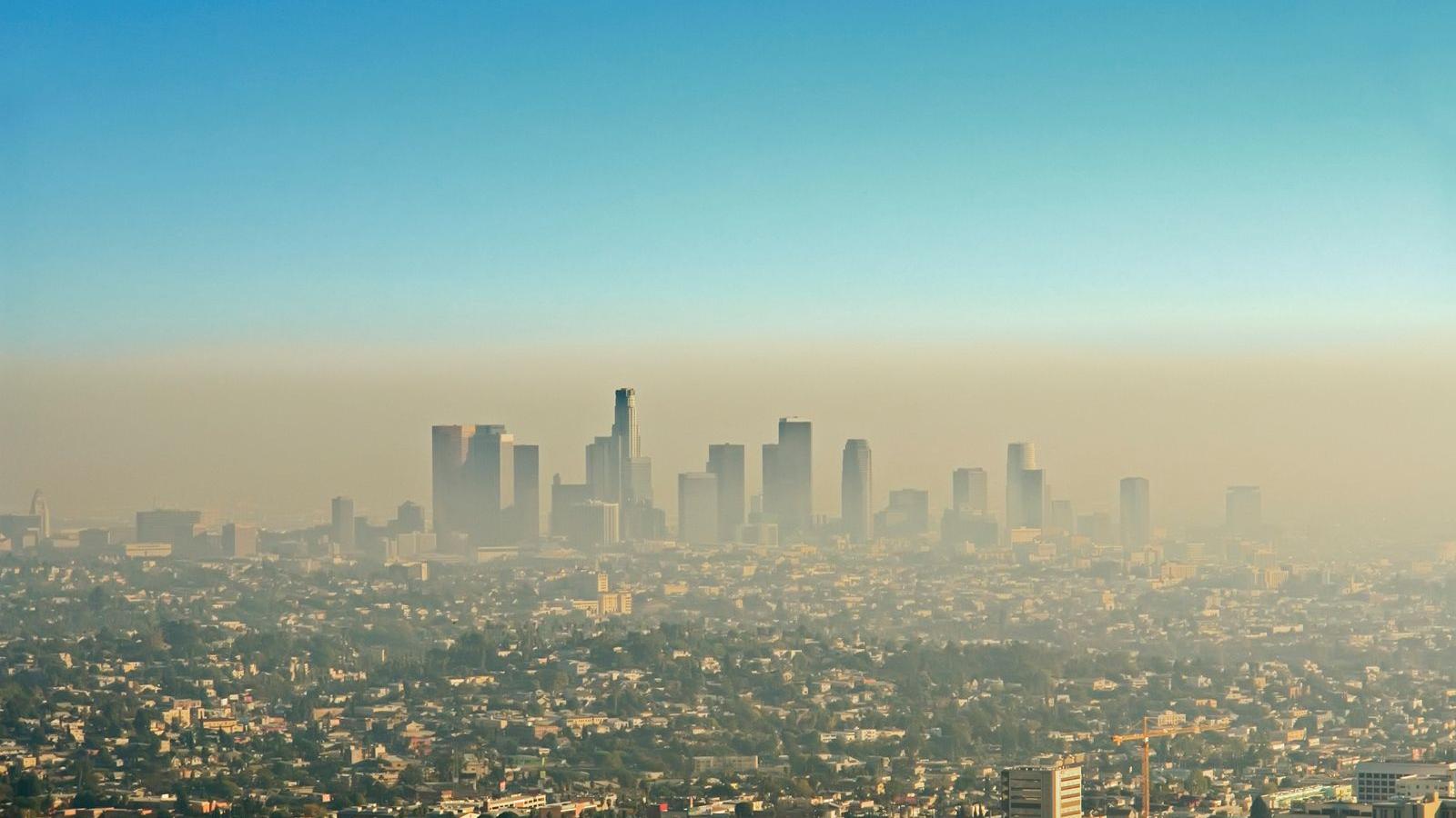 The Los Angeles city skyline obscured by a thick layer of ozone pollution smog
