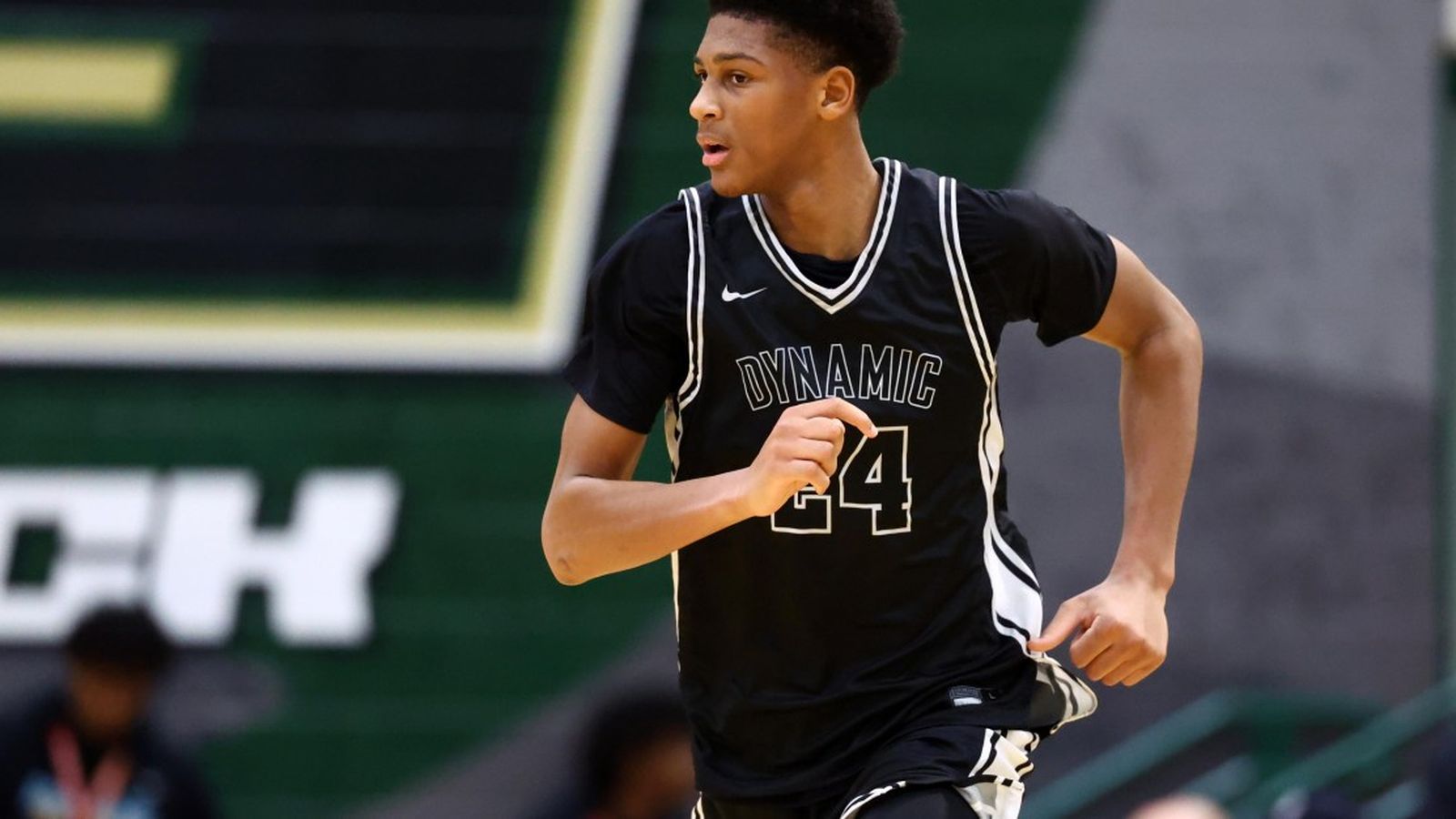 Basketball prospect Marcus Spears Jr. running on the court in a black jersey
