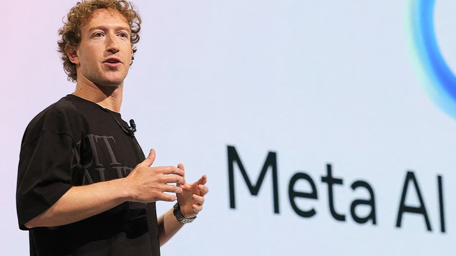 Mark Zuckerberg speaking on stage in front of a large Meta AI logo