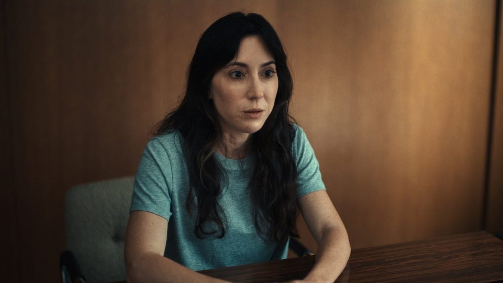 Michelle Hadley sitting at a desk during an interview for the documentary film