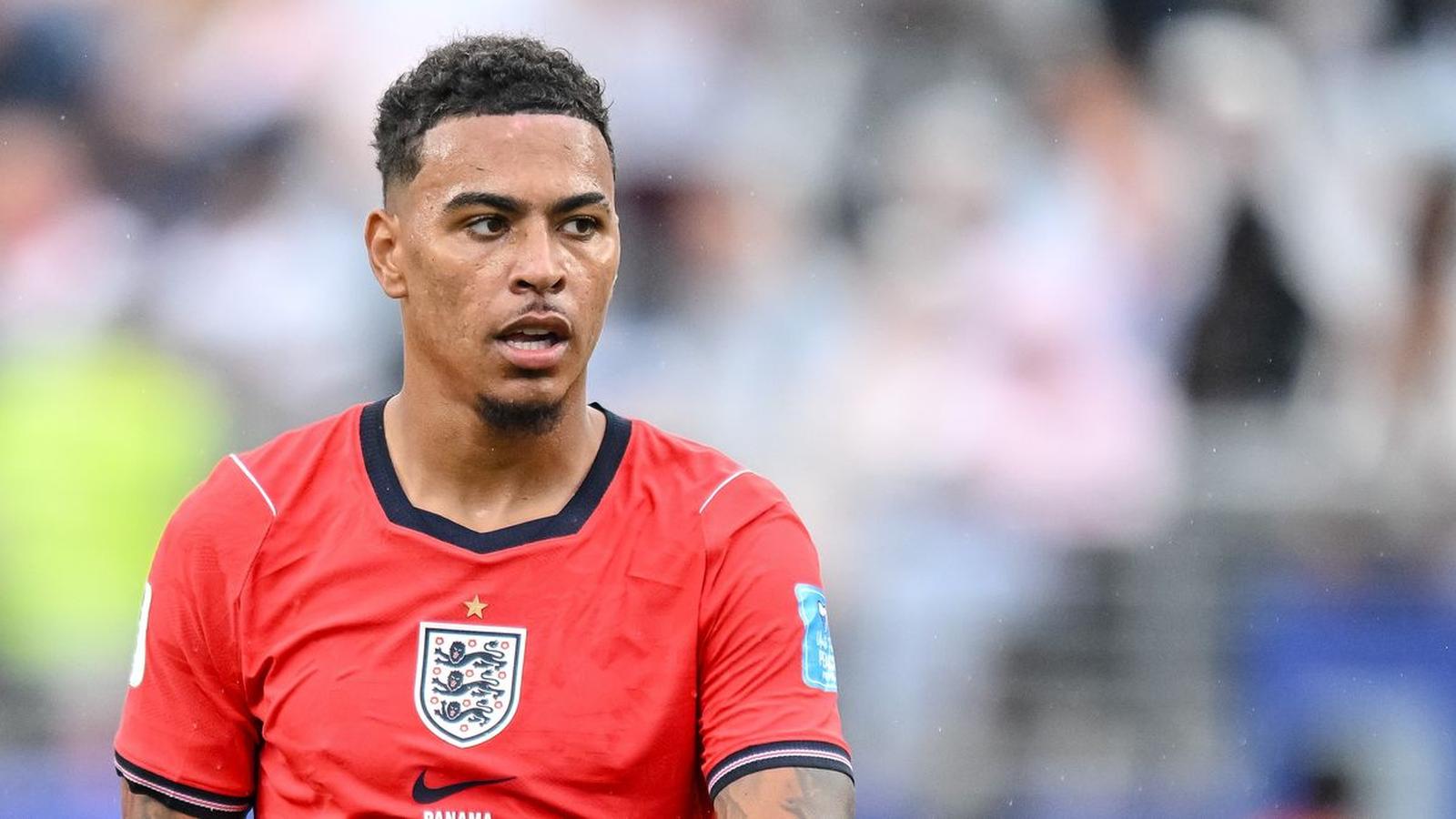 Morgan Rogers wearing the England national team red kit during a football match