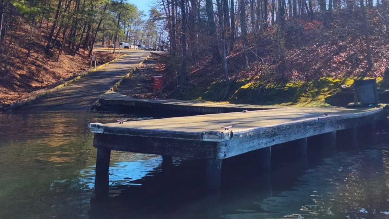 A wooden boat dock extending into the water at the Moundville public boat ramp