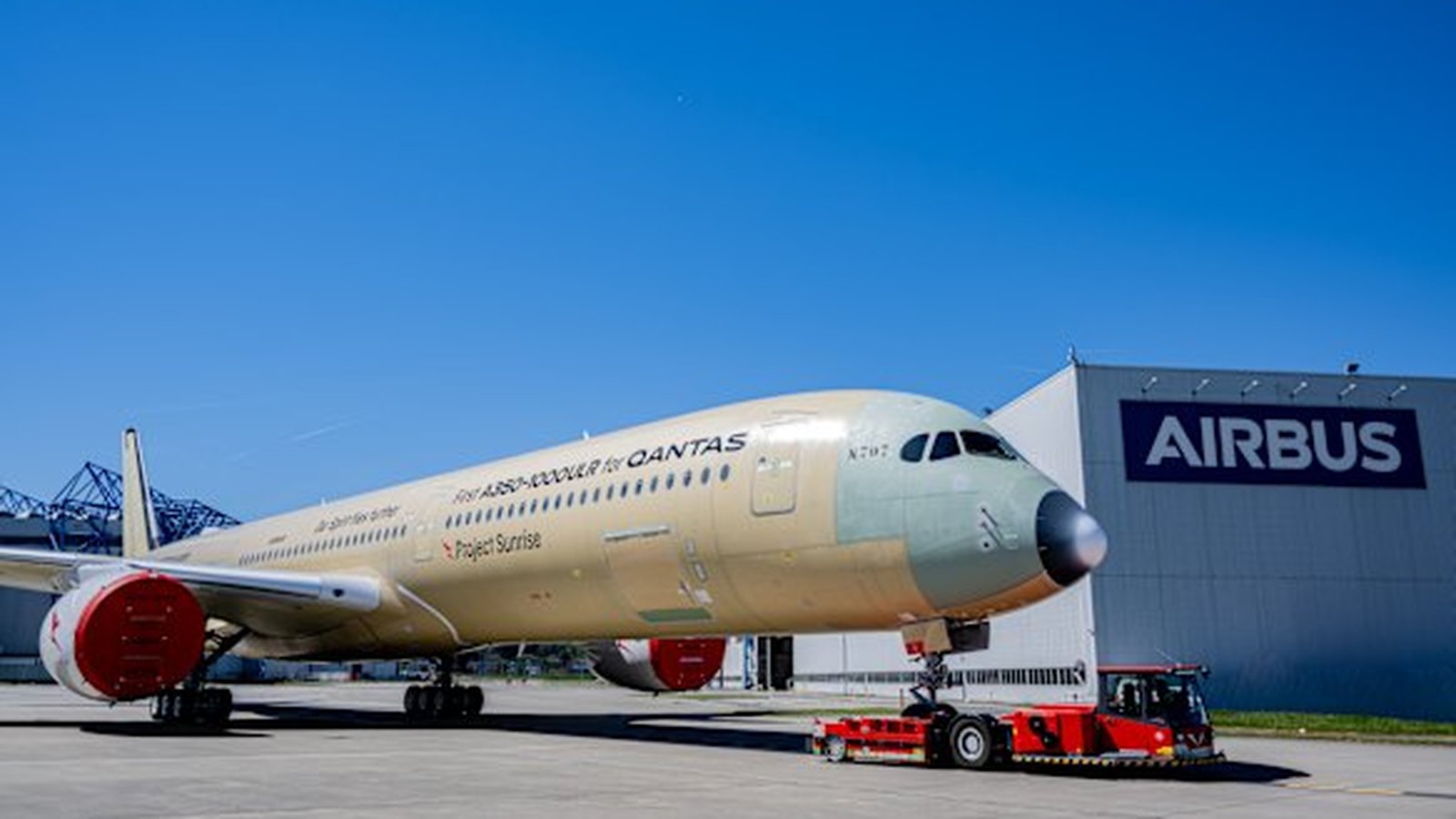 A Qantas Airbus A350-1000ULR aircraft being towed outside an Airbus hangar facility