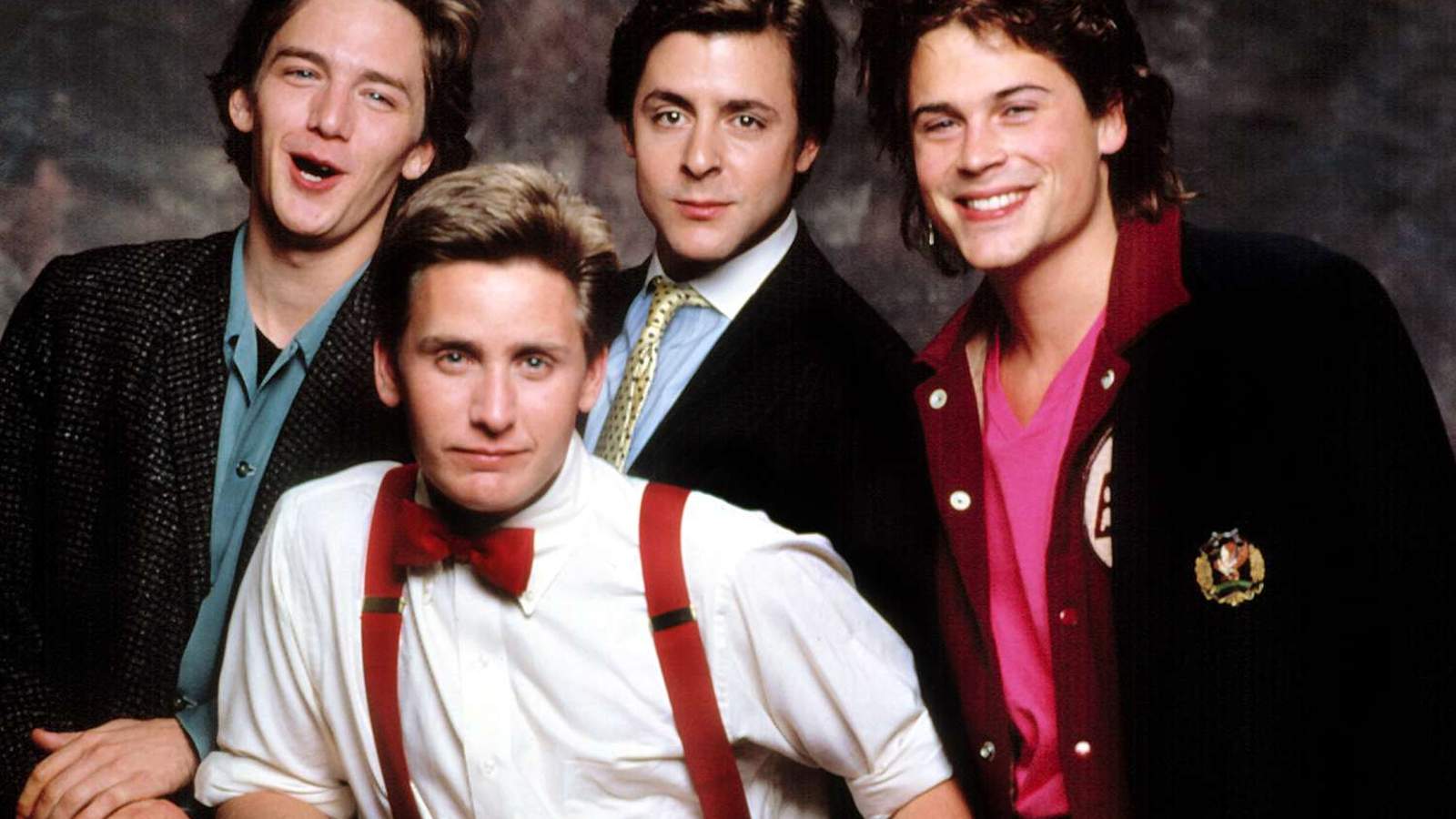 Rob Lowe posing with fellow Brat Pack actors in a 1980s studio portrait
