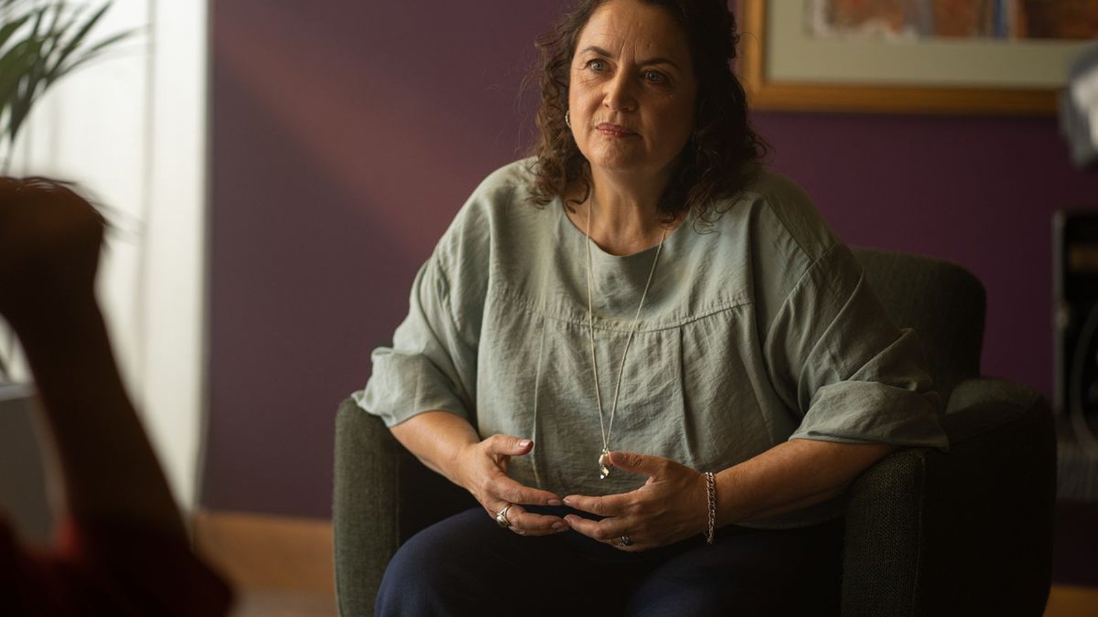 Ruth Jones sitting in an armchair during a scene from the BBC drama The Rapture