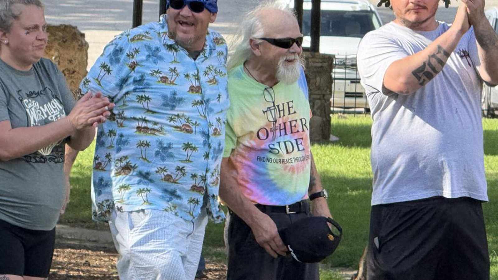 Four people standing together outdoors at a community recovery event in Searcy Arkansas