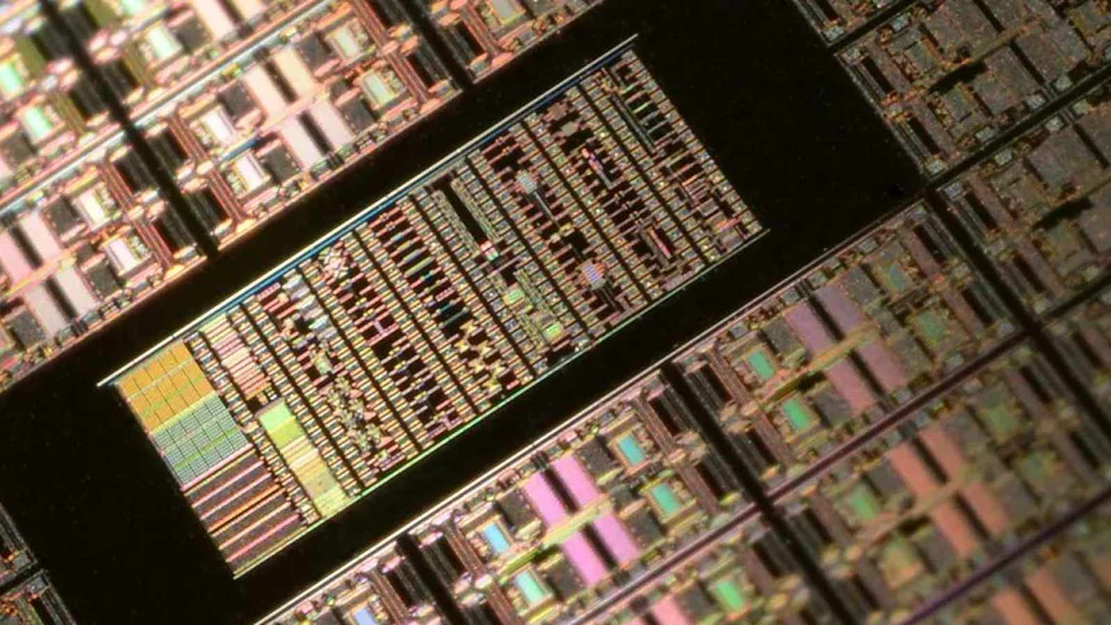 Close up view of a silicon wafer featuring intricate microchip die circuitry patterns