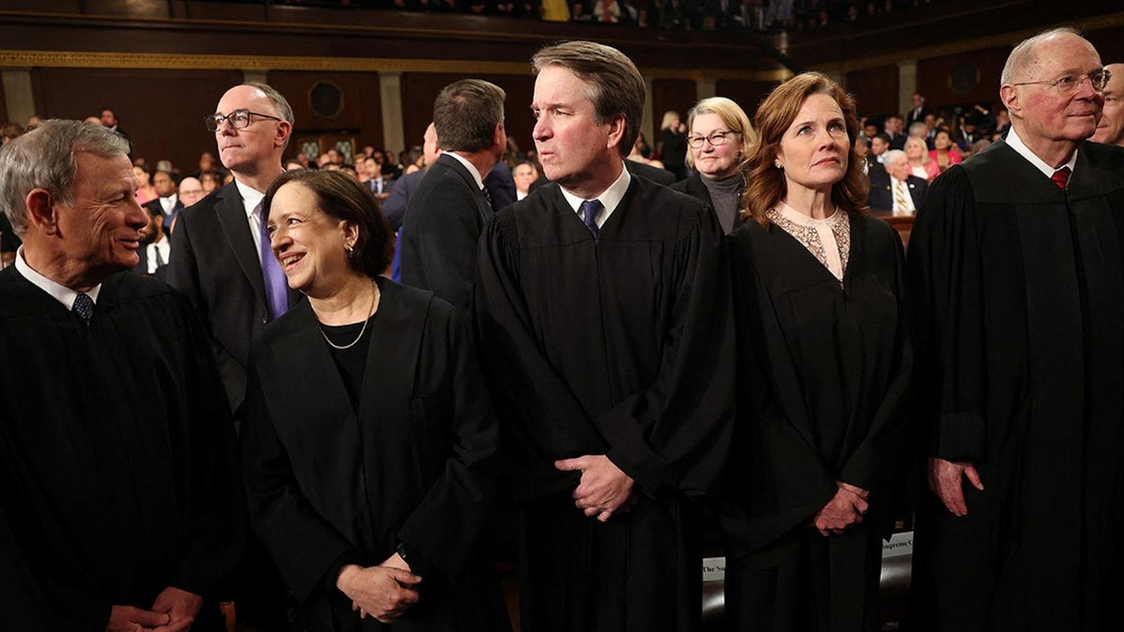Supreme Court Justices Elena Kagan and Amy Coney Barrett standing in judicial robes