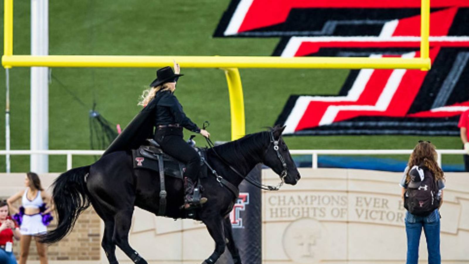 The Texas Tech Masked Rider on a black horse at the football stadium