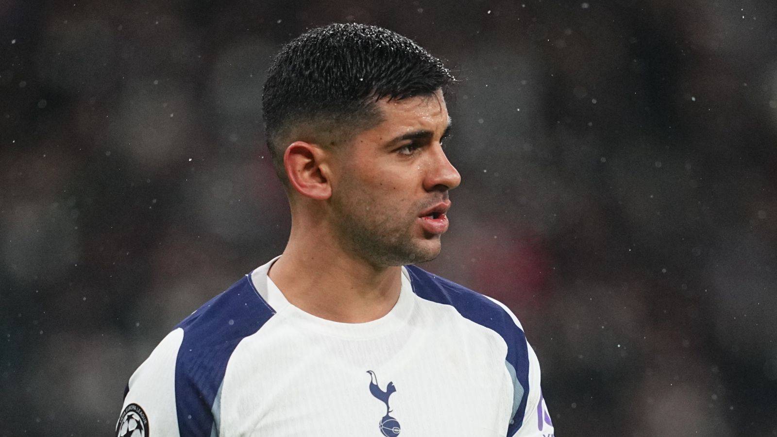 Tottenham Hotspur player Cristian Romero looking focused during a rainy match
