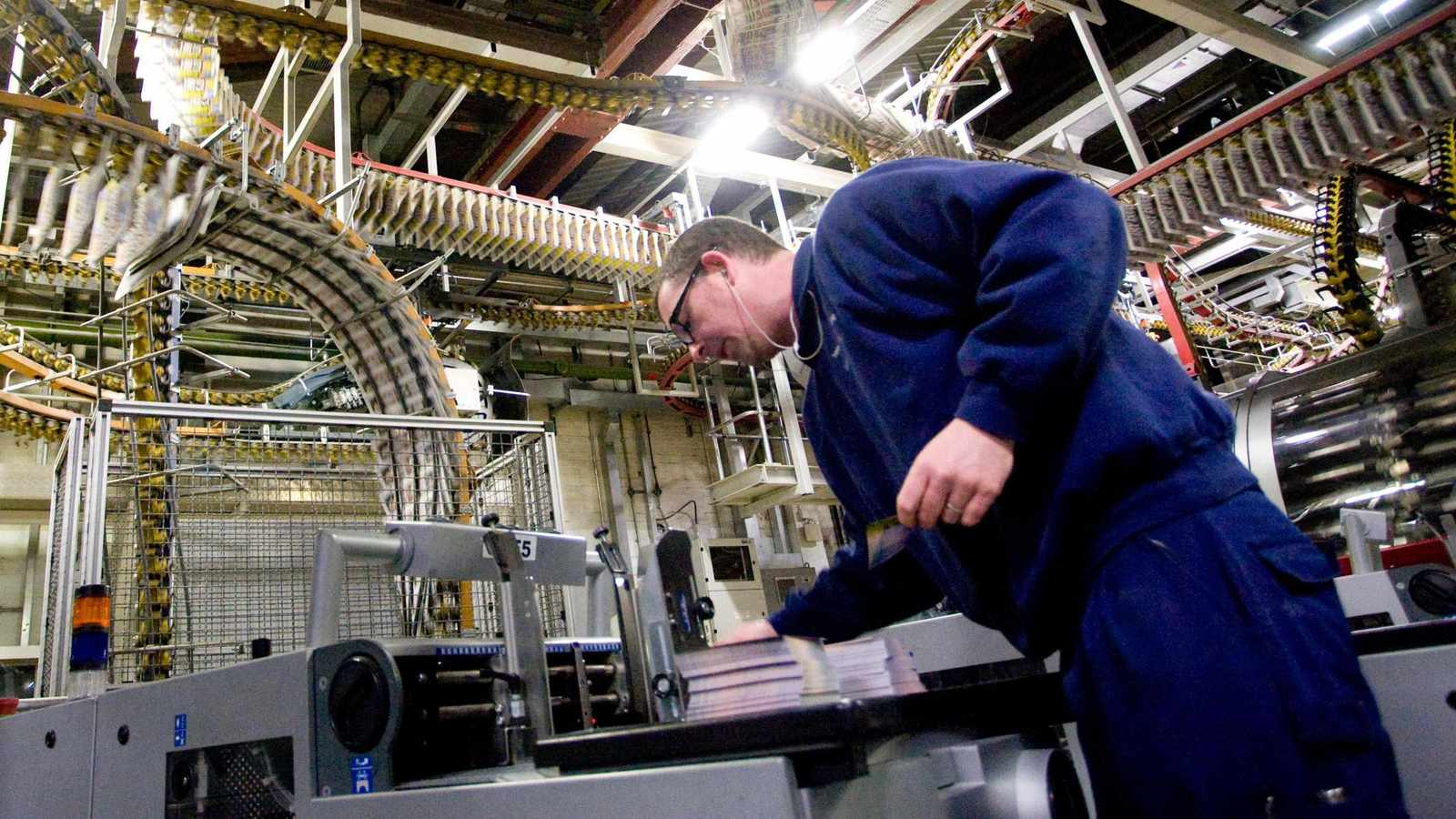 A worker monitors industrial printing machinery at the Daily Mirror Watford production facility
