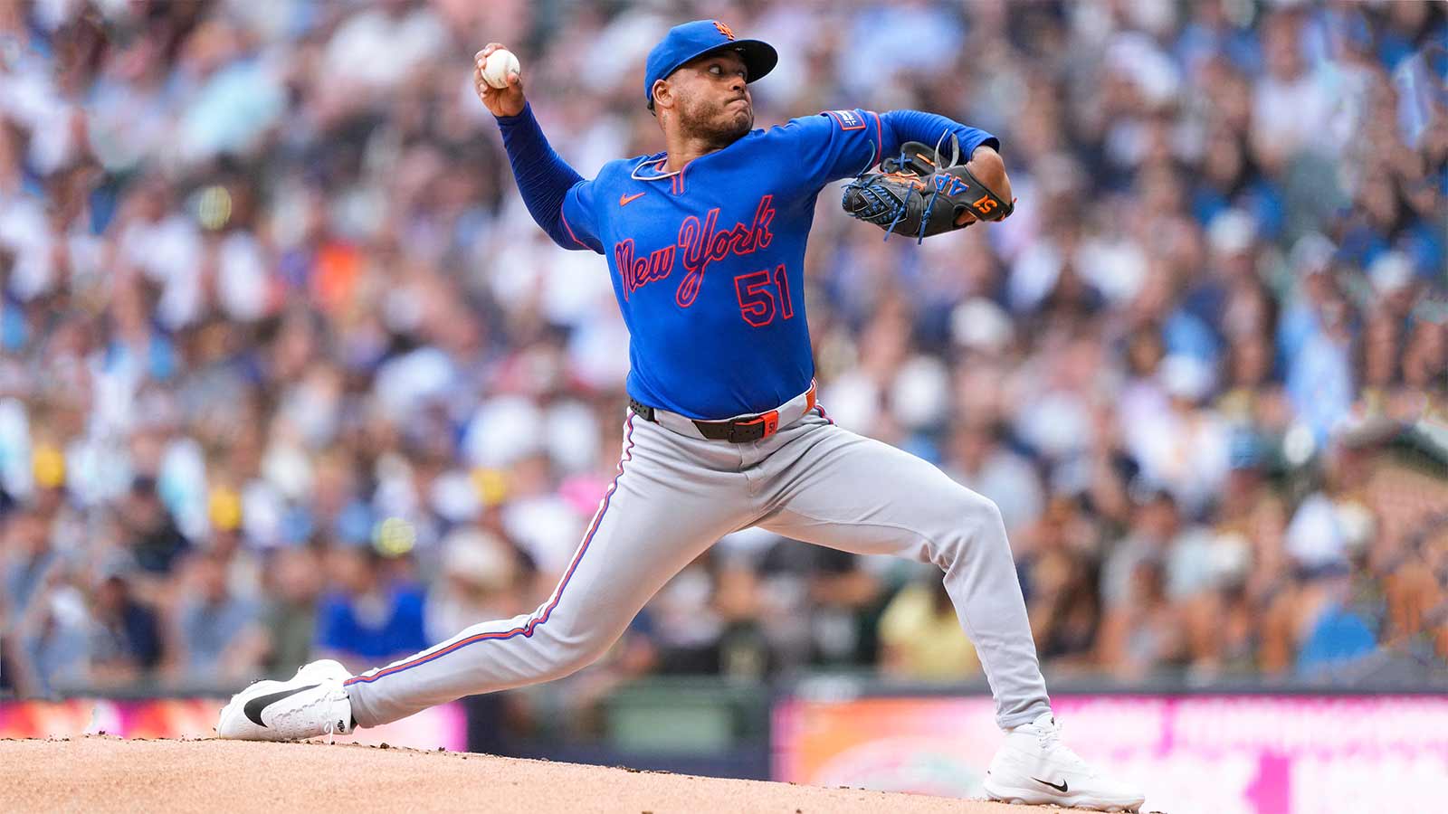 New York Mets pitcher Freddy Peralta throwing a baseball from the mound during game