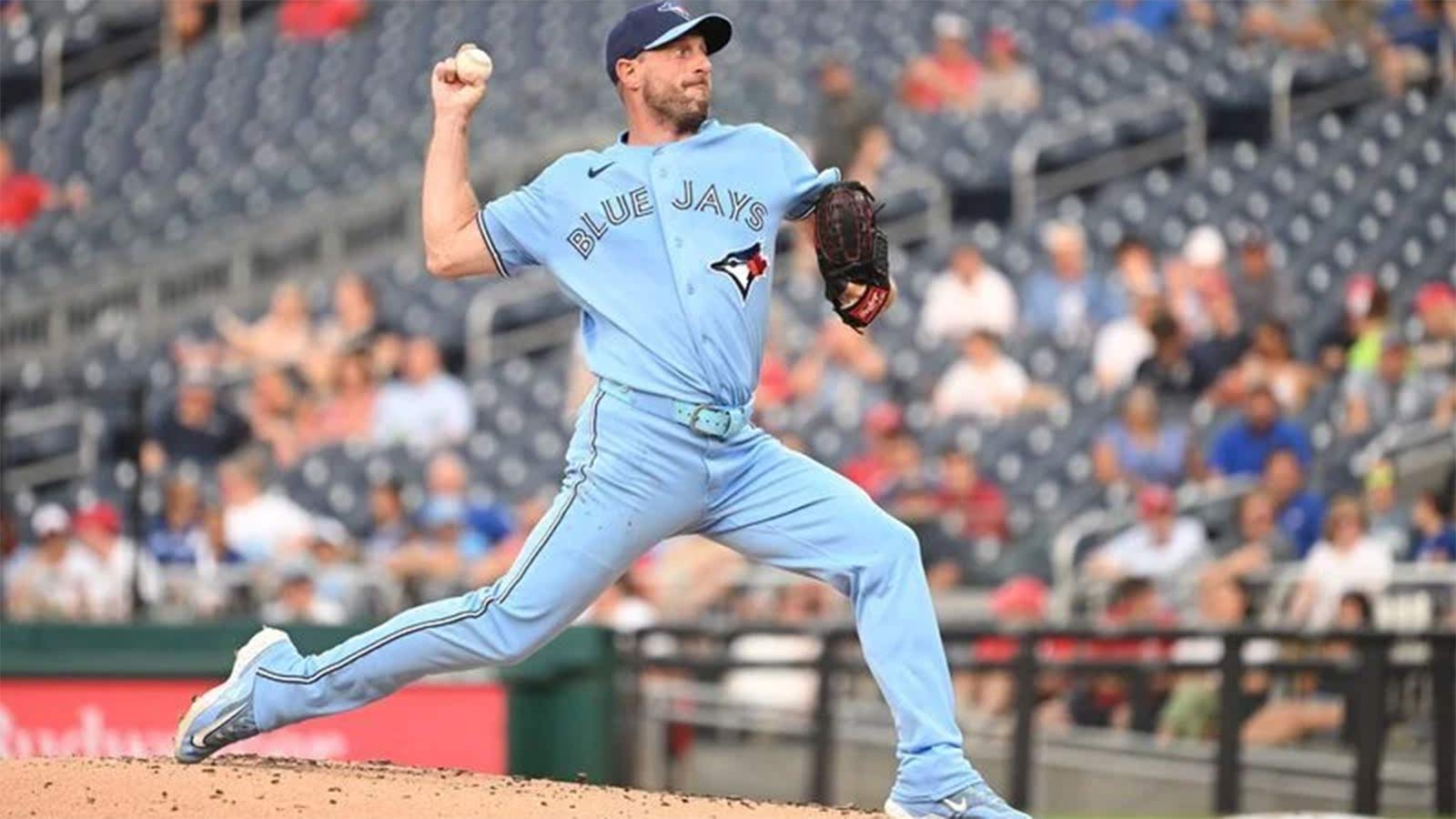 Max Scherzer in a light blue Toronto Blue Jays uniform pitching on the mound