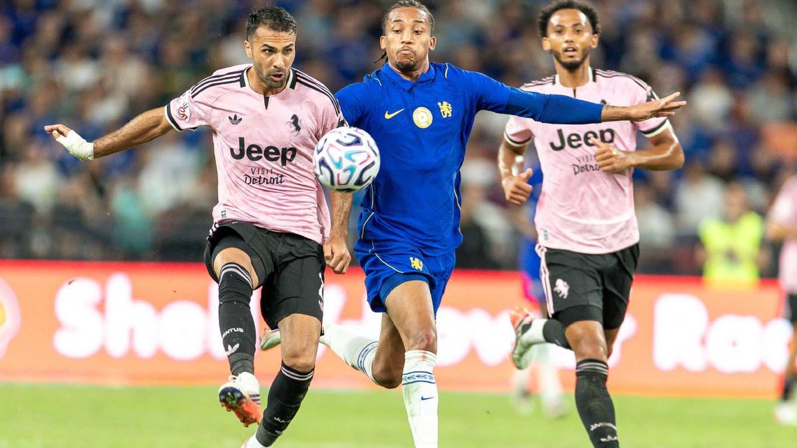 Chelsea and Juventus players competing for the ball during a pre-season football match