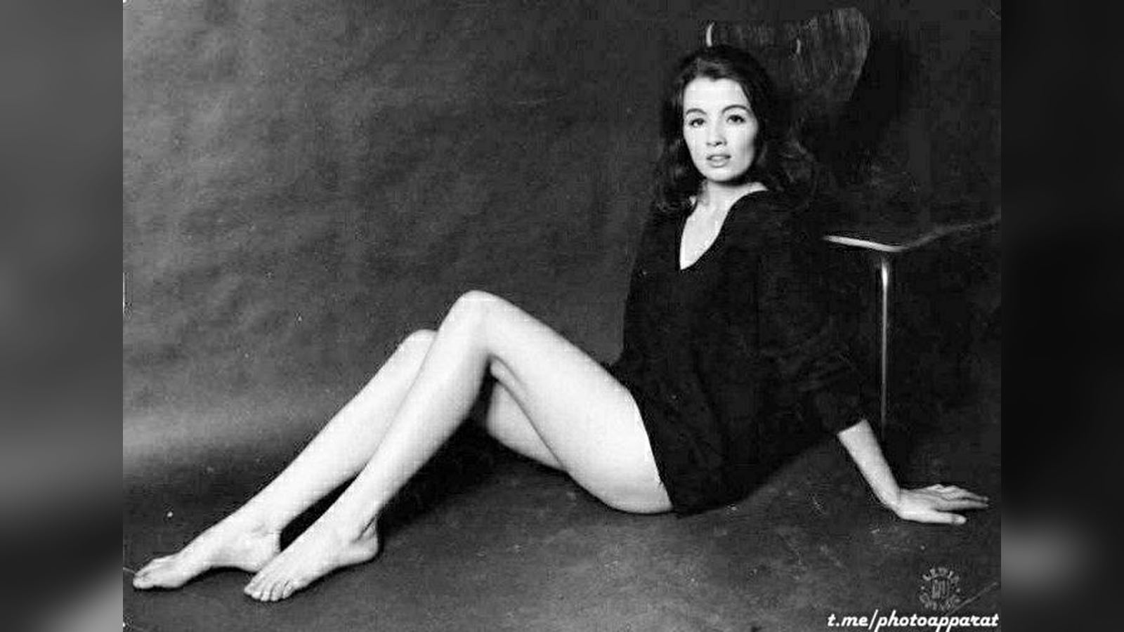 Christine Keeler sitting backwards on a plywood chair, 1963.