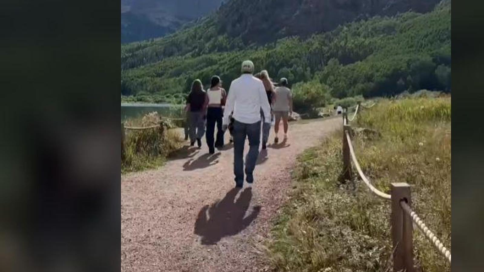 The Gaines family walking along a dirt path toward mountains in Colorado
