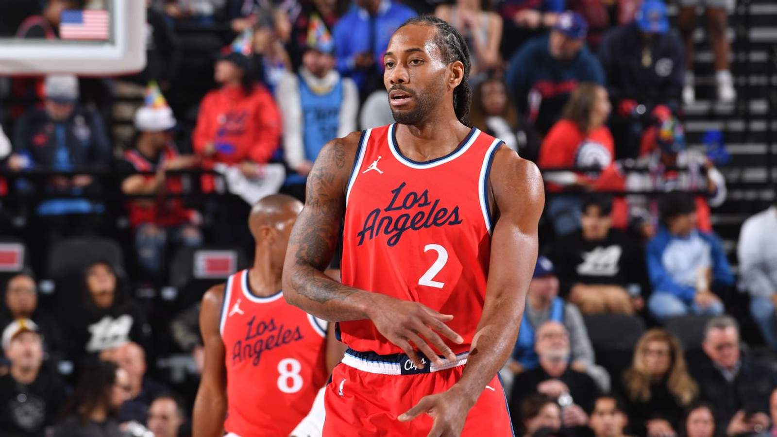 Kawhi Leonard wearing a red Los Angeles Clippers jersey on the basketball court