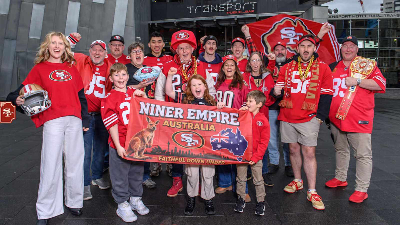 Group of San Francisco 49ers fans holding a Niner Empire Australia banner in Melbourne