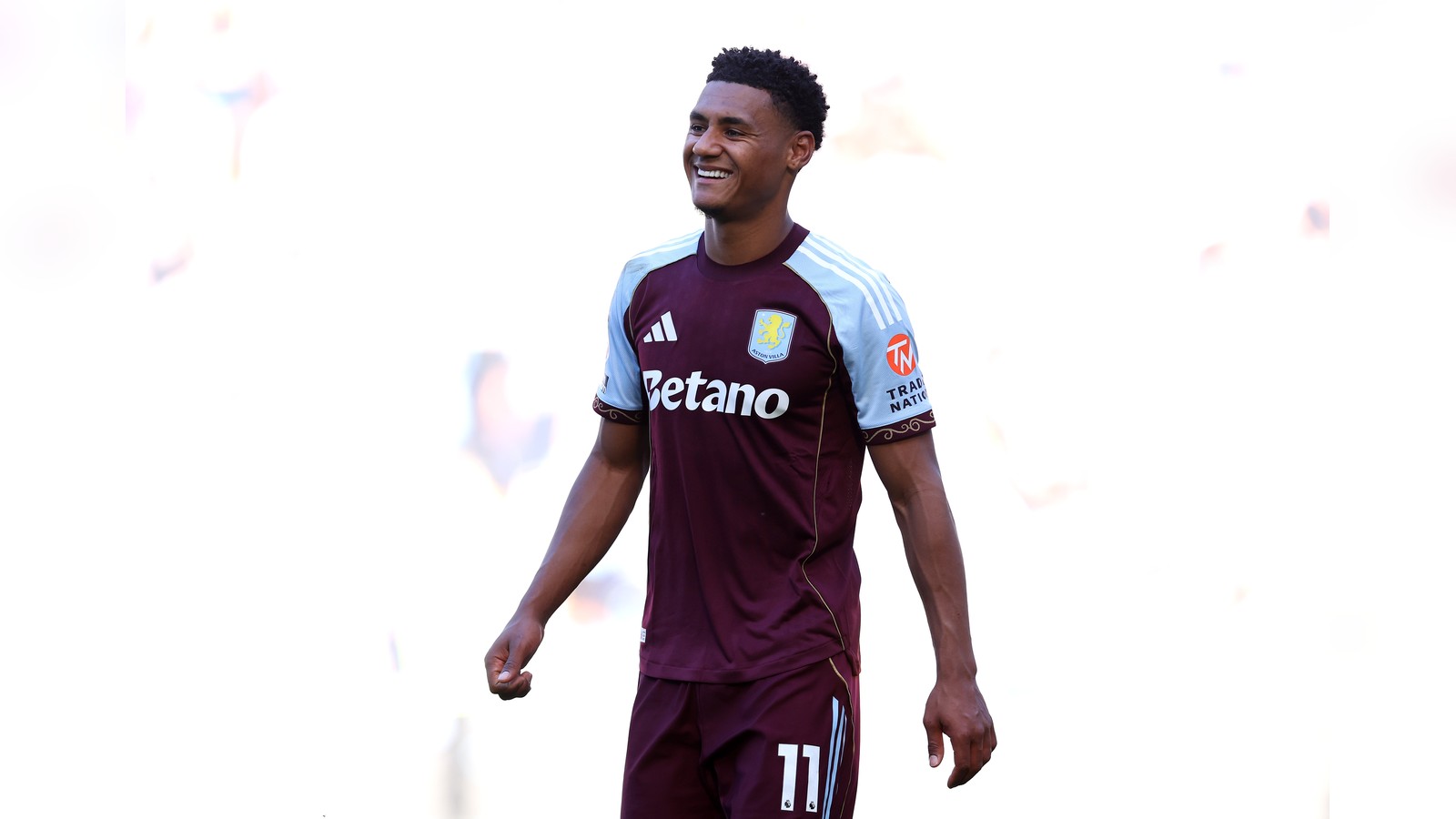 Ollie Watkins smiling while wearing the maroon and blue Aston Villa football kit