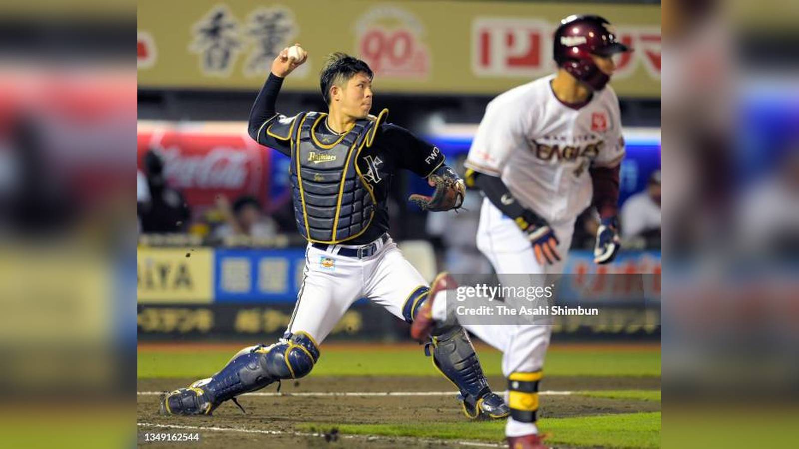 Orix Buffaloes catcher throwing the ball while a Tohoku Rakuten Golden Eagles player runs past