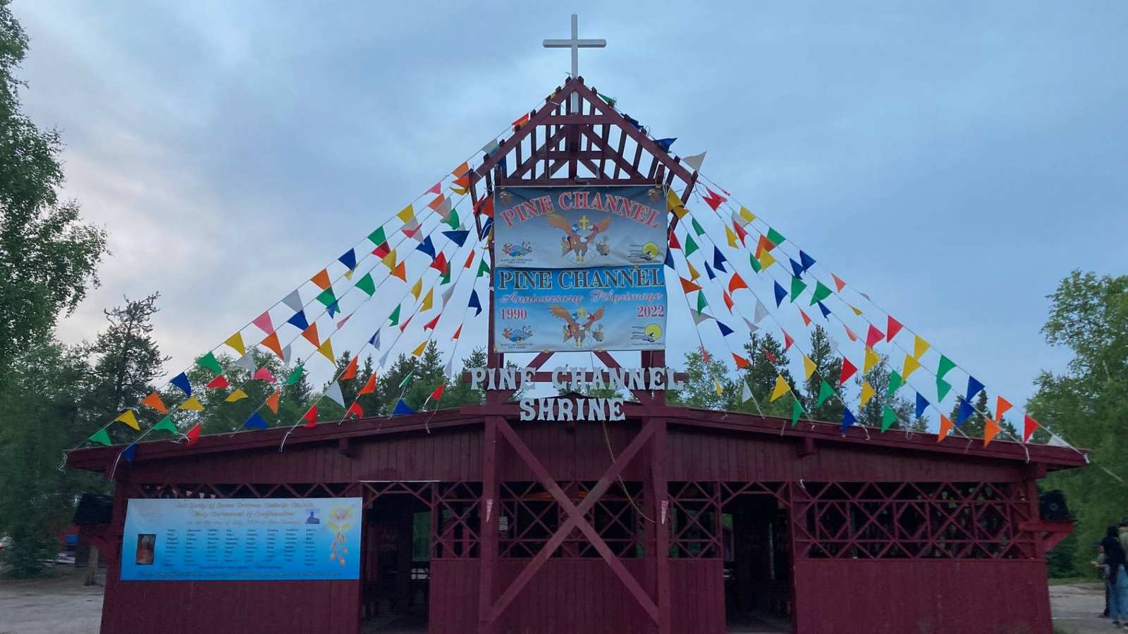 The wooden Pine Channel Shrine structure decorated with colorful flags for the annual pilgrimage