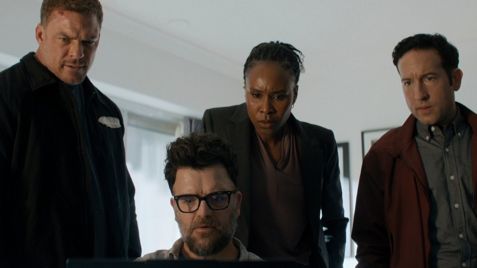 Alan Ritchson and his team looking at a laptop screen in Reacher season four