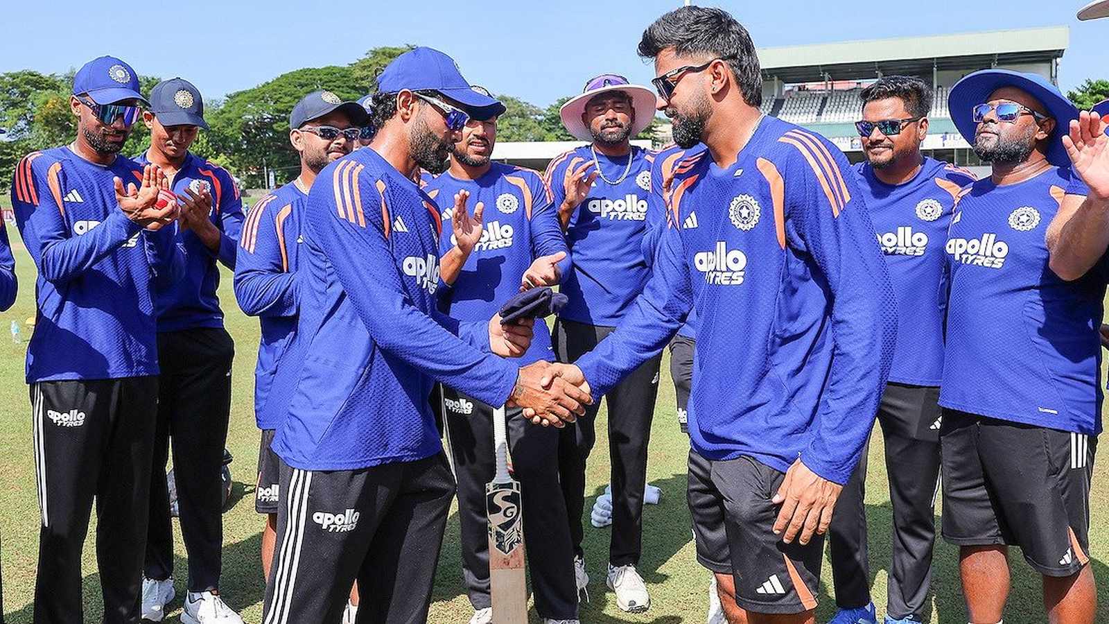 Saransh Jain shaking hands with a teammate during his Indian cricket team Test debut ceremony