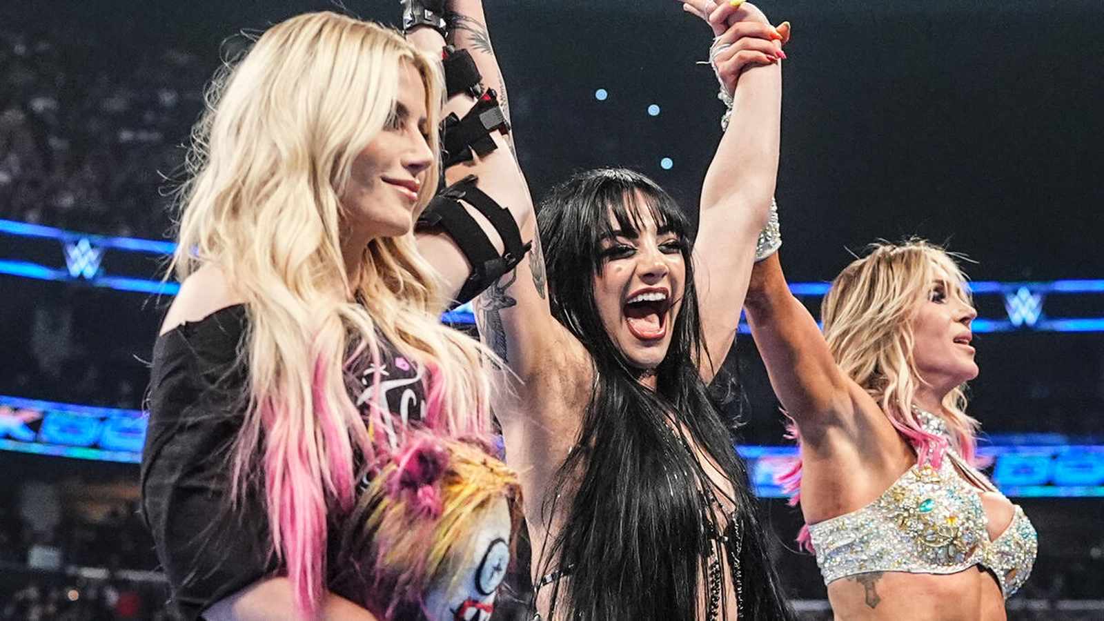 Tatum Paxley celebrating in the ring with Alexa Bliss and Charlotte Flair on SmackDown