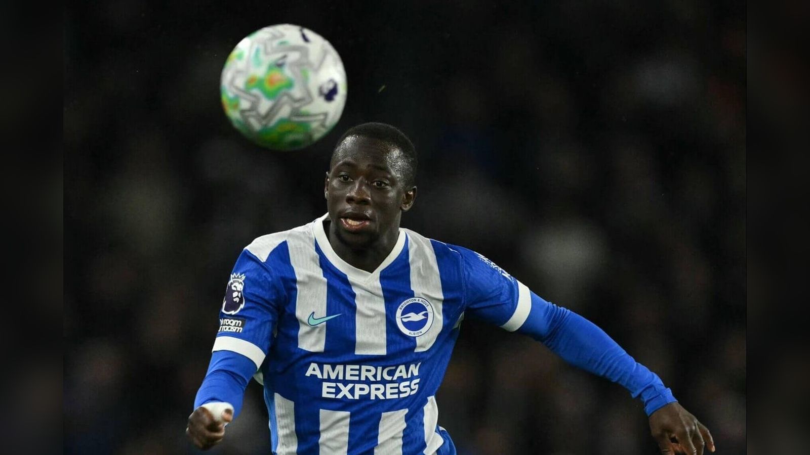 Brighton winger Yankuba Minteh playing in a match with a soccer ball nearby