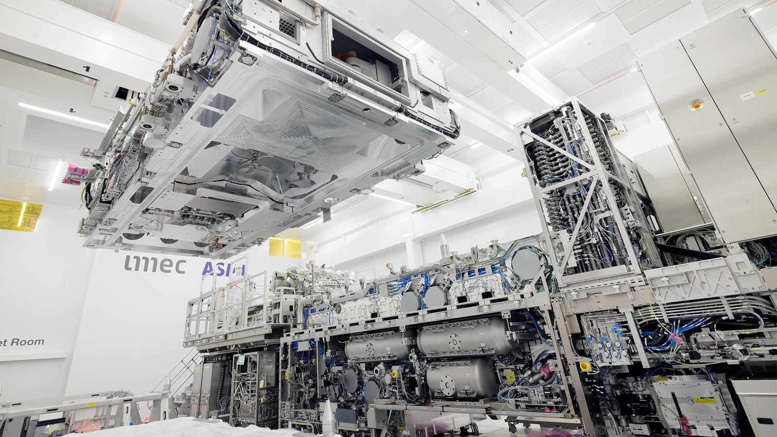 A large complex ASML high NA EUV lithography machine inside a cleanroom facility