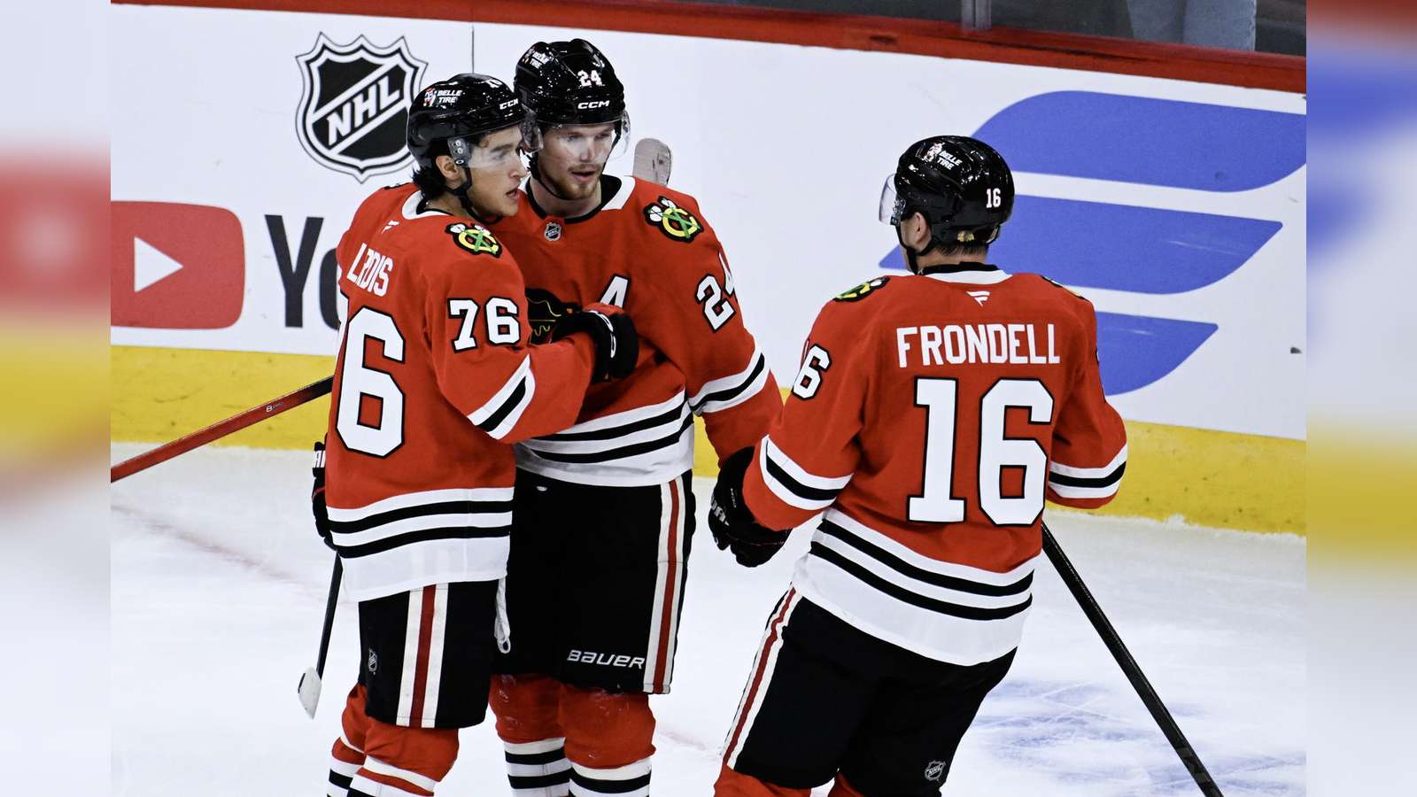 Chicago Blackhawks hockey players celebrating on the ice during a preseason game