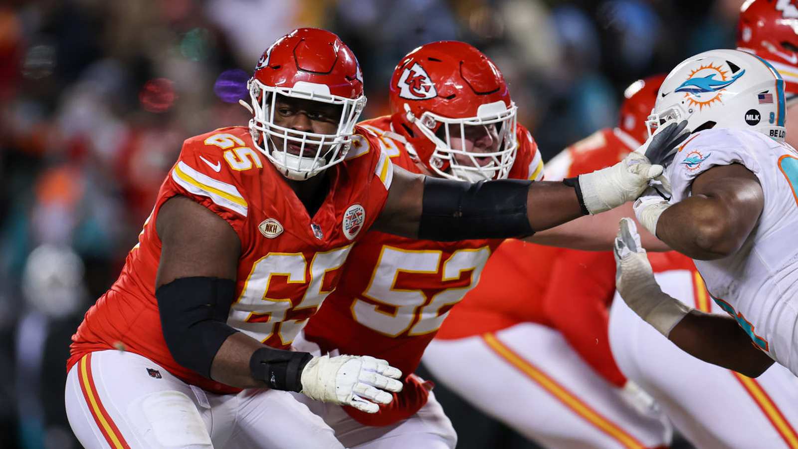 Kansas City Chiefs offensive linemen blocking during a professional football game on the field