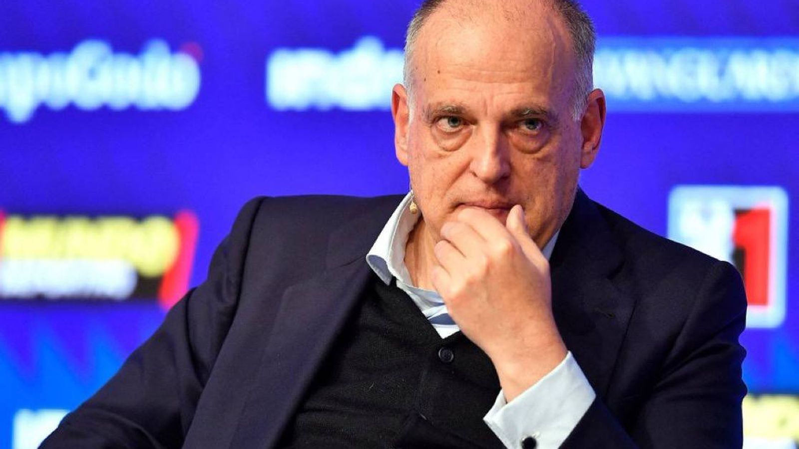 La Liga President Javier Tebas sitting thoughtfully at a press conference