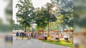 People gather at stalls during the Johnny Appleseed Fall Festival at Ariel-Foundation Park