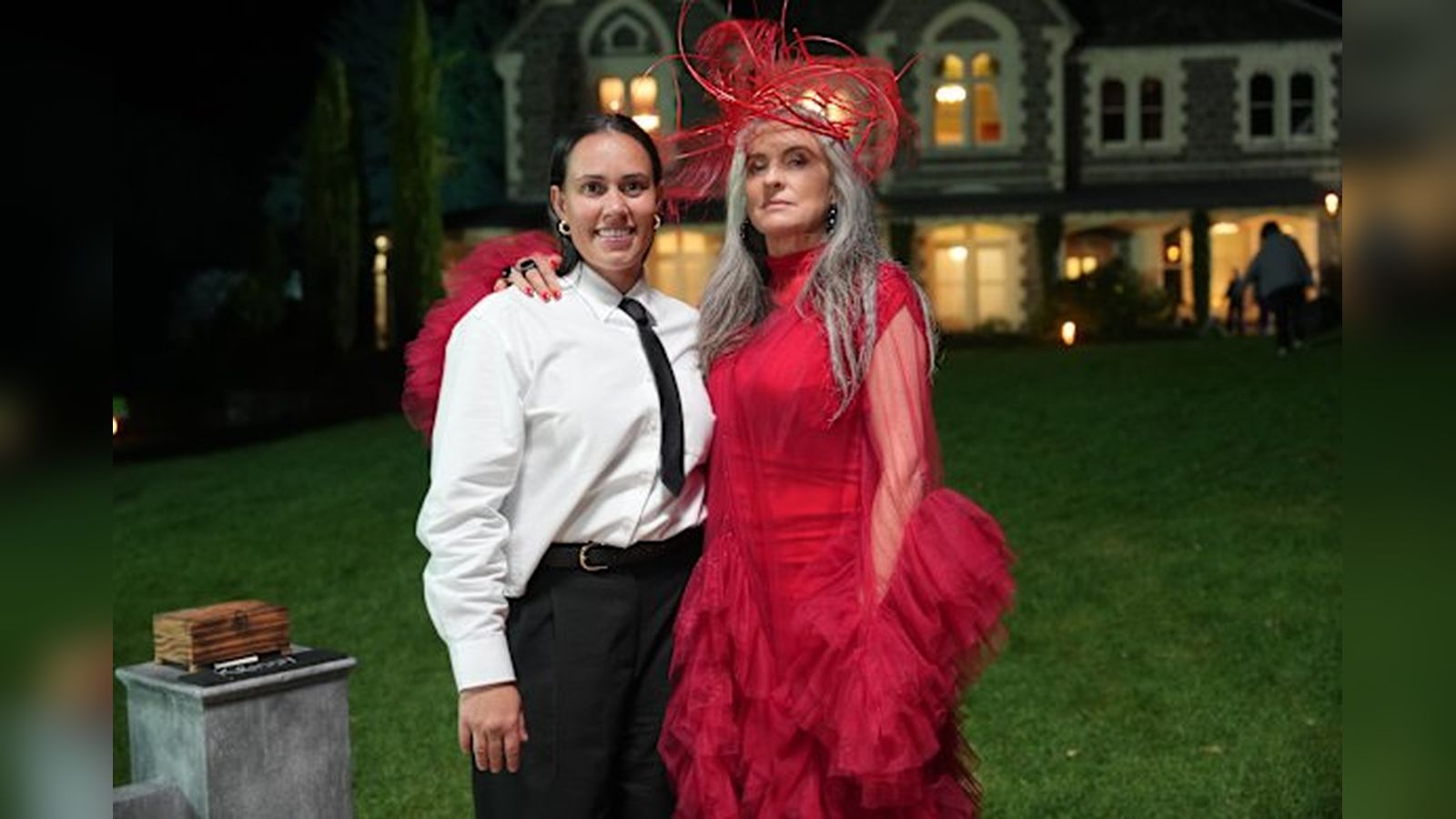 Kirby Bentley and a fellow contestant standing outside the Traitors Australia manor house
