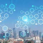 A digital network of glowing blue hexagons superimposed over a modern city skyline