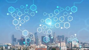 A digital network of glowing blue hexagons superimposed over a modern city skyline