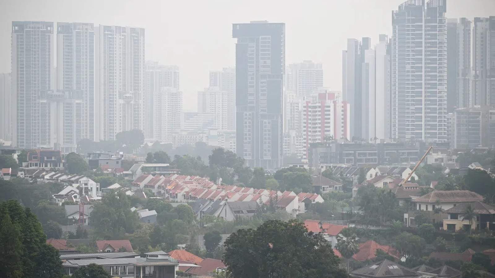 A hazy view of the Singapore skyline with residential buildings obscured by air pollution
